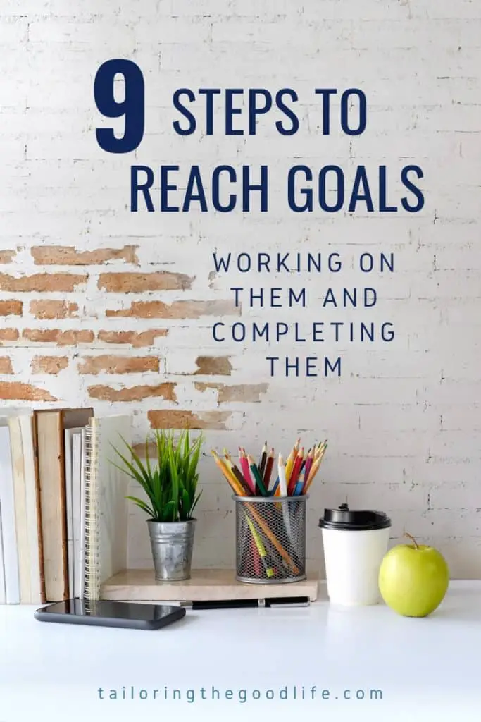 Workspace with office accessories, a mobile phone, a cup of coffee and an apple - 9 Steps to Reach Goals