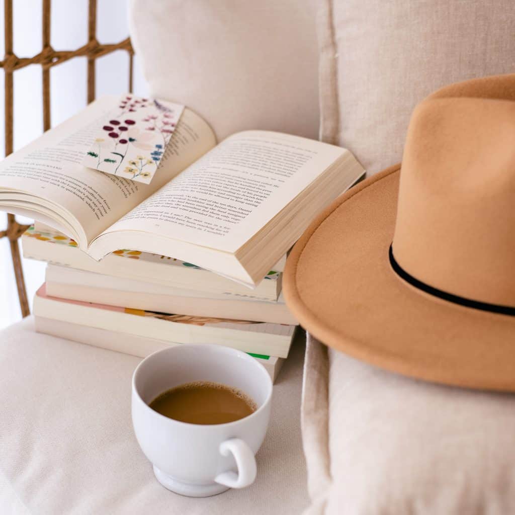 comfy chair with a pile of books, a cup of coffee and a hat - Time for You, time for a good book - take time to read