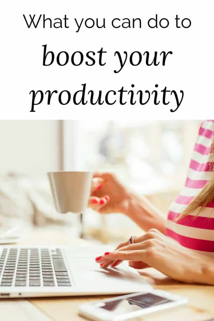 lady with a cup of coffee behind a laptop - boost your productivity